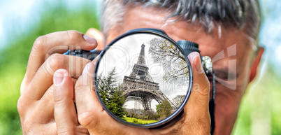 Photographer taking photo with DSLR camera at Eiffel Tower. Shal