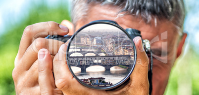 Photographer taking photo with DSLR camera at Florence cityscape