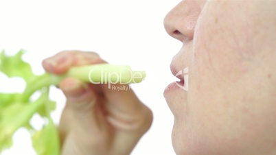 Woman Eats Organic Celery Closeup