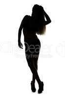 Silhouette ofyoung girl with hands on head