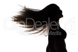 Silhouette of girl with waving hair in profil