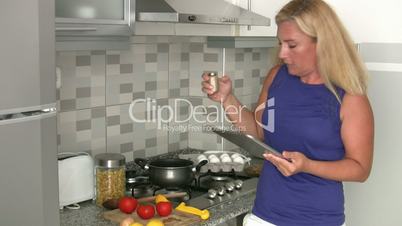 Woman cooking  in her kitchen at home