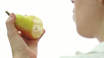 Female Eating Pear Over Shoulder