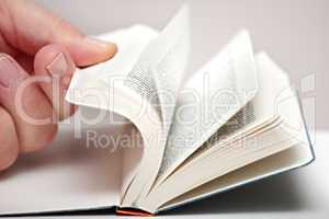Hand leafing through the book