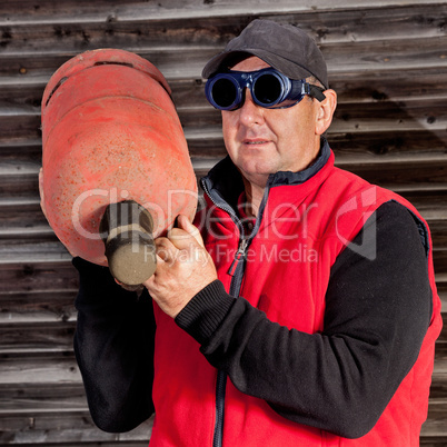 Construction worker with gas bottle