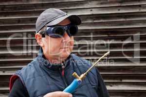 Construction worker with goggles and gas burner