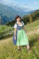 Woman in Dirndl in the mountains