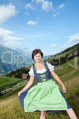 Woman in Dirndl in the mountains