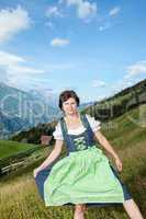 Woman in Dirndl in the mountains