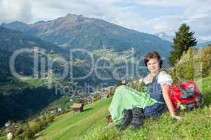 Woman in Dirndl enjoys the mountains