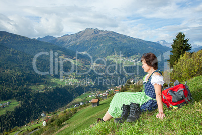 Woman in Dirndl enjoys the mountains