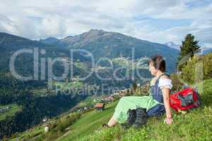 Woman in Dirndl enjoys the mountains