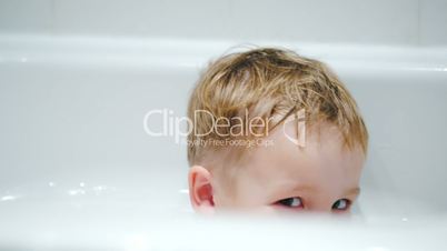 Little smiling boy in the bath