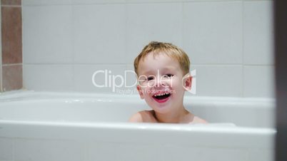 Laughing boy in the bath