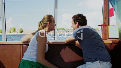 Young couple traveling by touristic boat