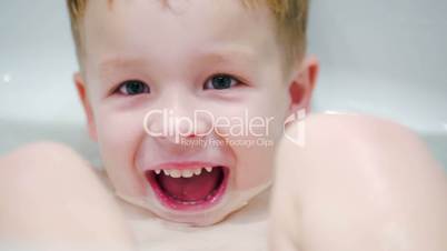 Little laughing boy in the bath
