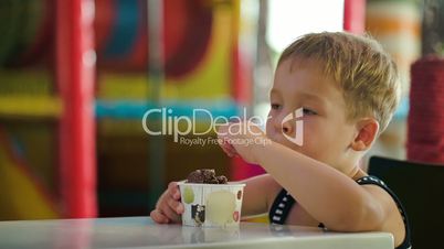 Little boy eating chocolate ice cream