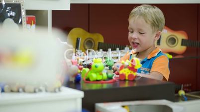 Boy playing with toys in game room