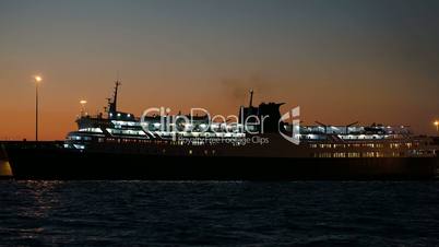 Illuminated cruise ship in late evening