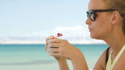 Woman eating ice-cream on the beach