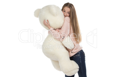 Photo of teenage girl hugging teddy bear