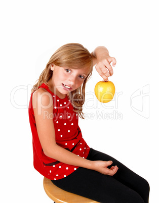 Girl playing with an apple.