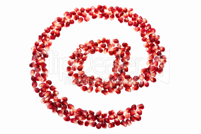 At symbol made from pomegranate seeds
