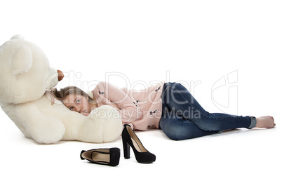 Image of teenage girl lying with teddy bear