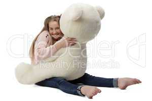 Portrait of girl hugging teddy bear