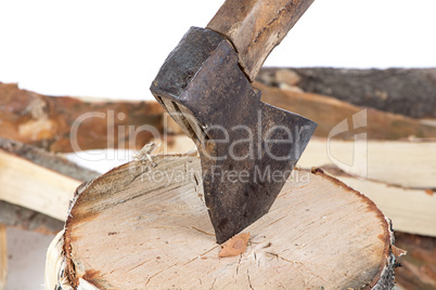 Photo of axe in the stump and firewoods