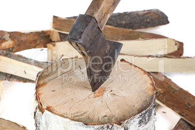 Image of axe in the stump and firewoods