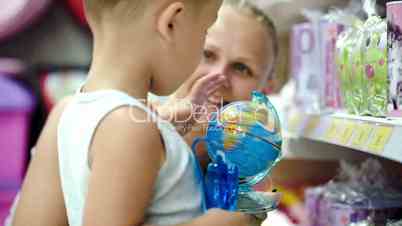 Mother and son with small globe in the shop