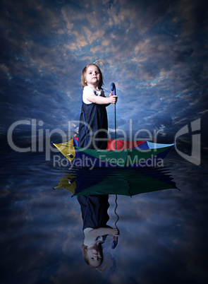 Little girl sailing using the umbrella
