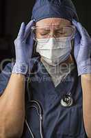 Grimacing Female Doctor or Nurse Wearing Protective Wear