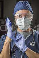 Concerned Female Doctor or Nurse Putting on Protective Facial We