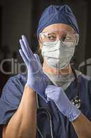 Concerned Female Doctor or Nurse Putting on Protective Facial We