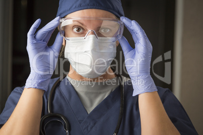 Female Doctor or Nurse Putting on Protective Facial Wear