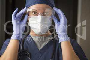 Female Doctor or Nurse Putting on Protective Facial Wear