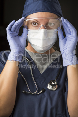 Female Doctor or Nurse Putting on Protective Facial Wear