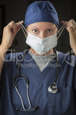 Female Doctor or Nurse Putting on Protective Face Mask