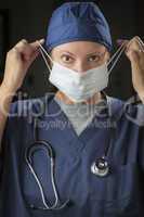 Female Doctor or Nurse Putting on Protective Face Mask