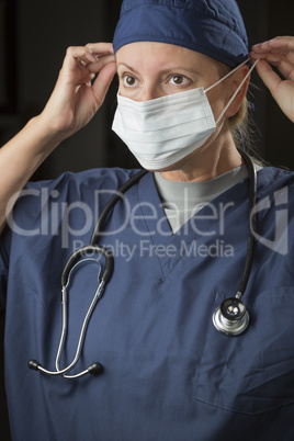 Female Doctor or Nurse Putting on Protective Face Mask
