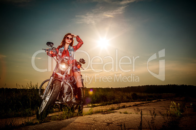 Biker girl sitting on motorcycle