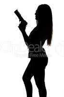 Silhouette of young sexy woman with gun