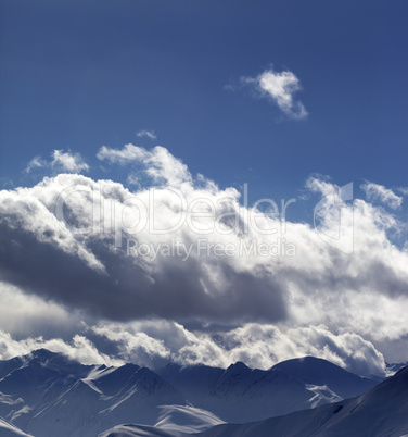 Evening sunlight mountains in clouds