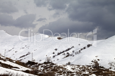 Off-piste slope and overcast sky