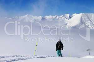Snowboarder on snowy slope with new fallen snow