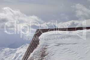 Roof of hotel in snow and winter mountains