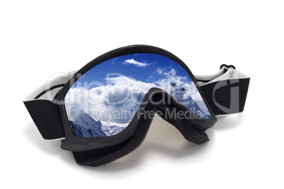 Ski goggles with reflection of snowy mountains
