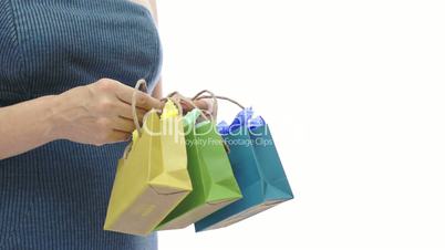 Woman and Three Small Colored Gift Bags